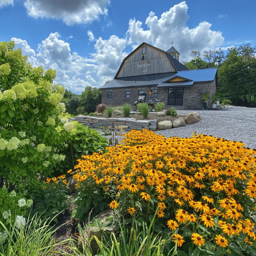 Wedding Barn Exterior with Garden of Flowers in forefront