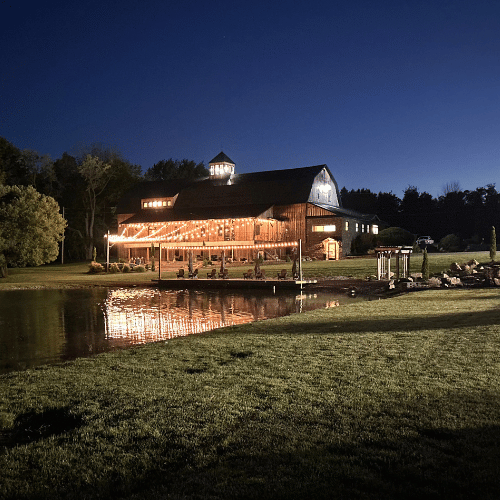 The Reception Barn and Dock by the Pond at Night